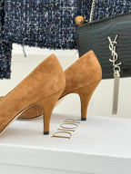 Tan suede pointed-toe stiletto pumps with sculpted heel and side cut detail