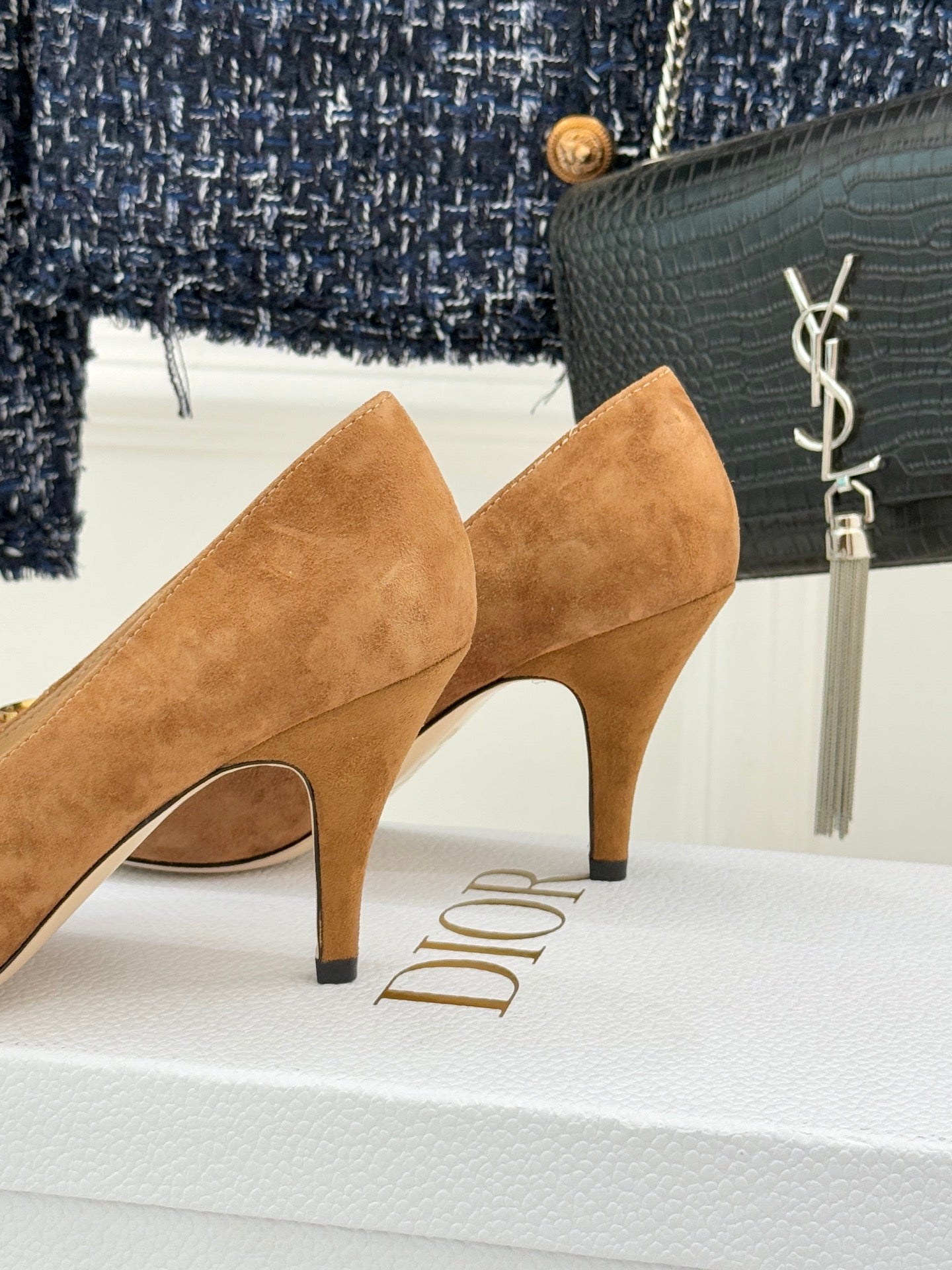 Tan suede pointed-toe stiletto pumps with sculpted heel and side cut detail