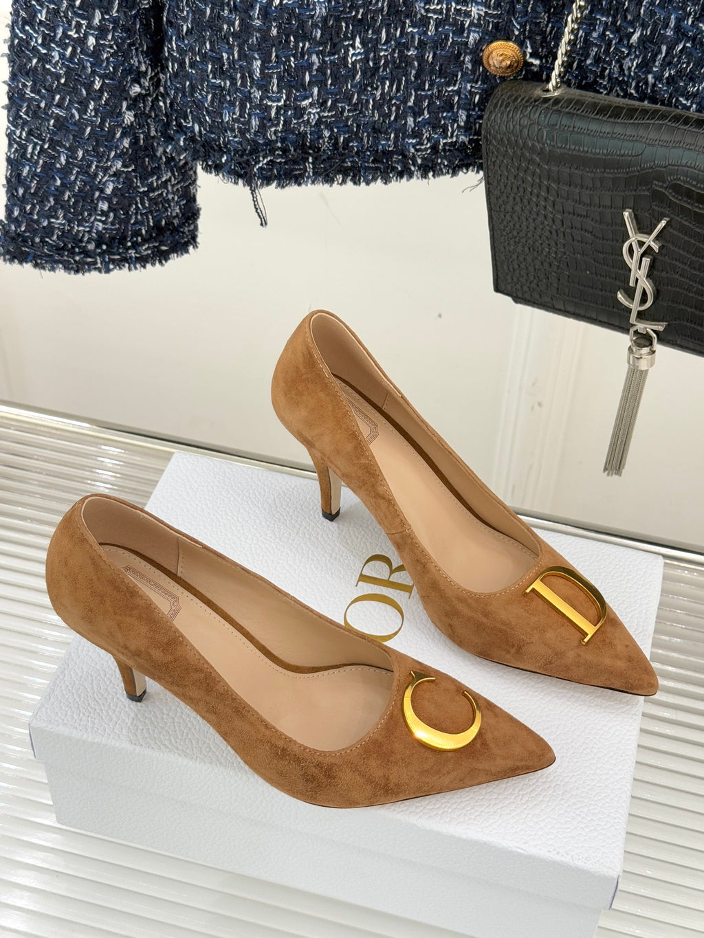 Pair of tan suede pointed-toe stiletto pumps with gold D and C emblems