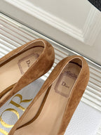 Tan suede pointed-toe pumps with Dior-branded insole and gold D emblem