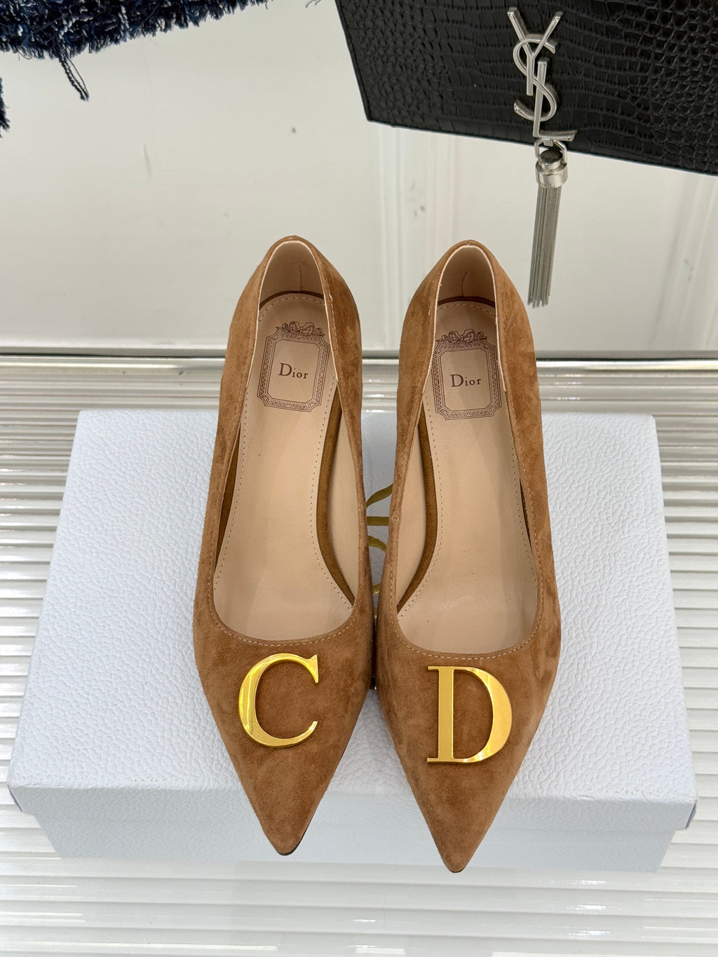 Tan suede pointed-toe pumps with gold C and D logo emblems
