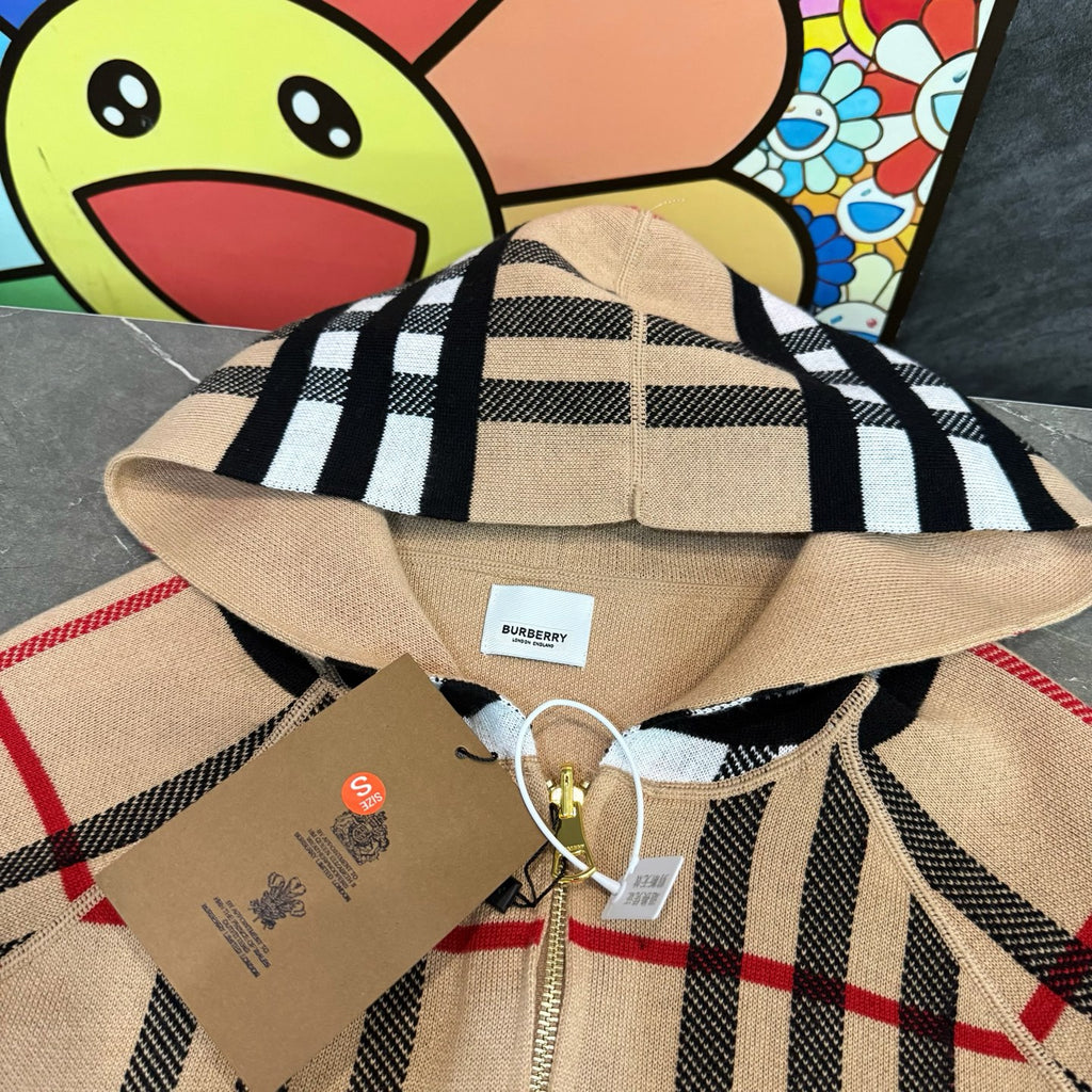 Plaid hooded zip jacket close-up in beige, black, and cream stripes