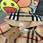 Plaid hooded zip jacket close-up in beige, black, and cream stripes