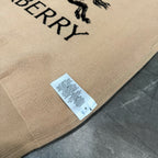 Beige fabric hem with size label and partial Burberry logo