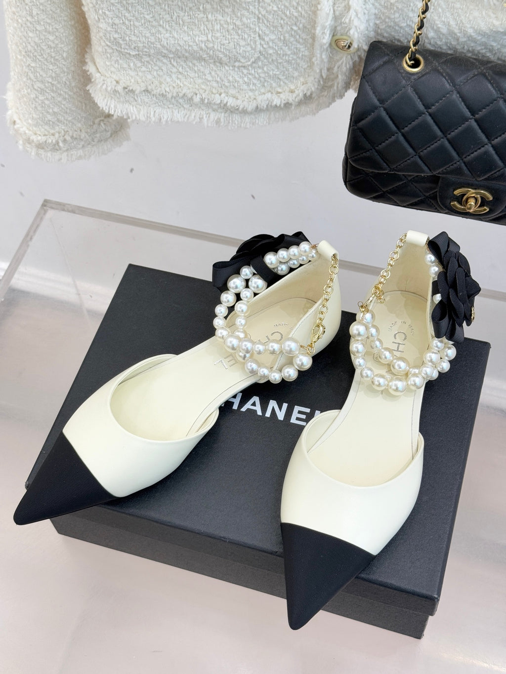 Chanel ladies' white flats with black pointed toe, pearl bead strap and bow detail