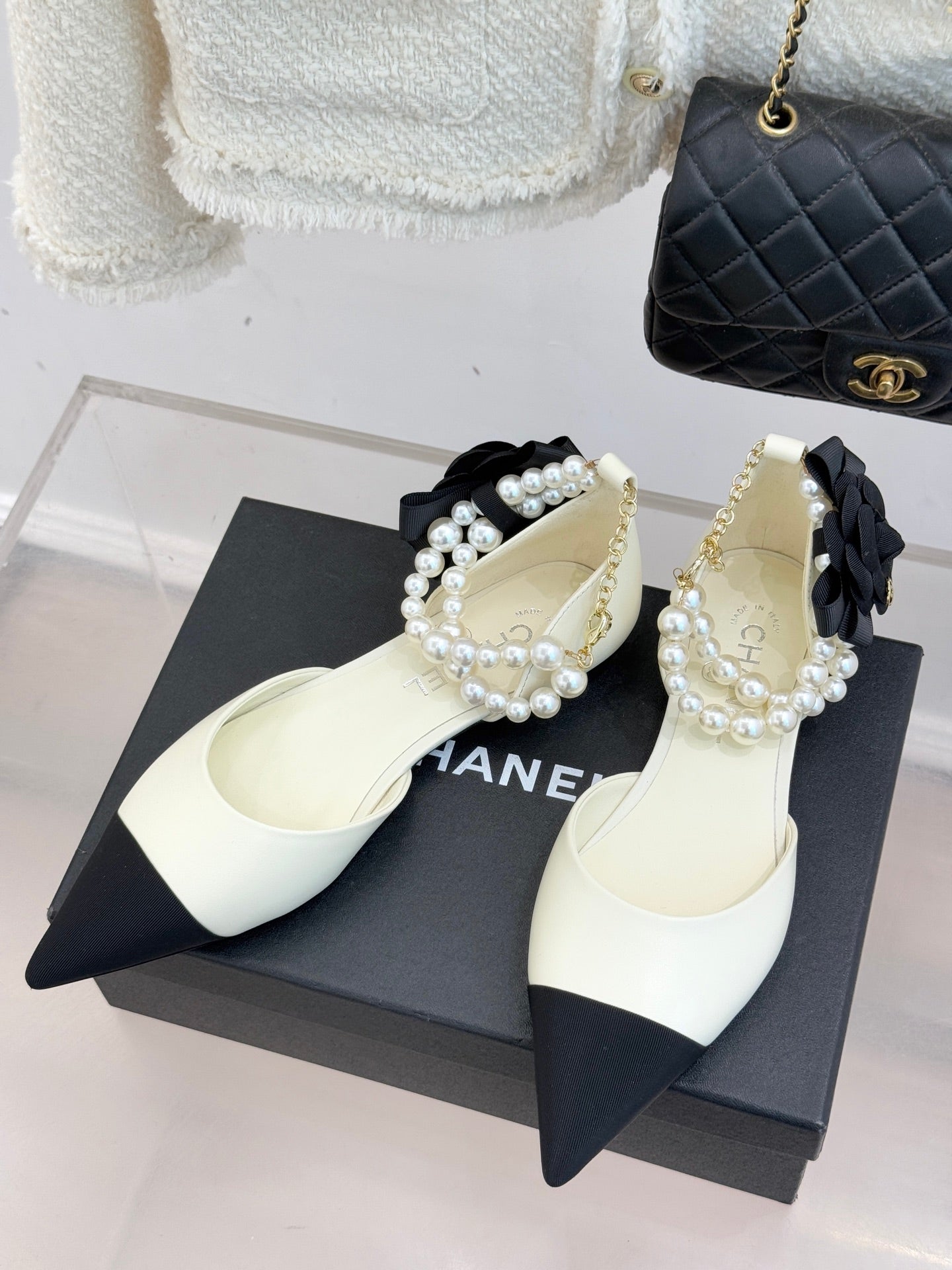 Chanel ladies' white flats with black pointed toe, pearl bead strap and bow detail