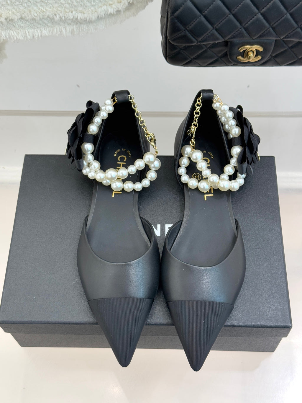 Chanel ladies black pointed mules with pearl bow strap and gold chain detail