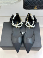 Chanel ladies black pointed mules with pearl bow strap and gold chain detail