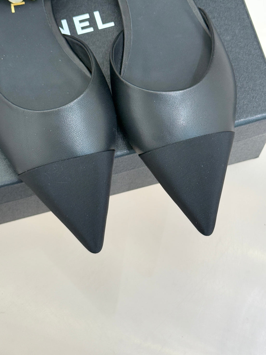 Chanel ladies black mules with pointed toe and slim heel, side view