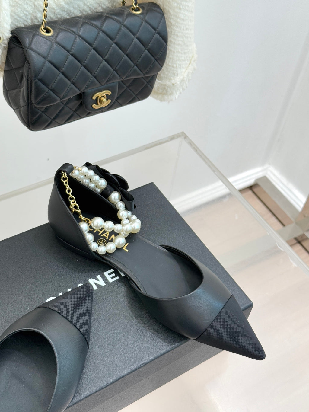 Chanel ladies black leather mules with pearl beaded strap and pointed toe, shown with bag