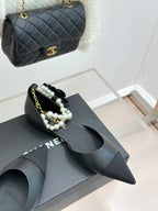 Chanel ladies black leather mules with pearl beaded strap and pointed toe, shown with bag