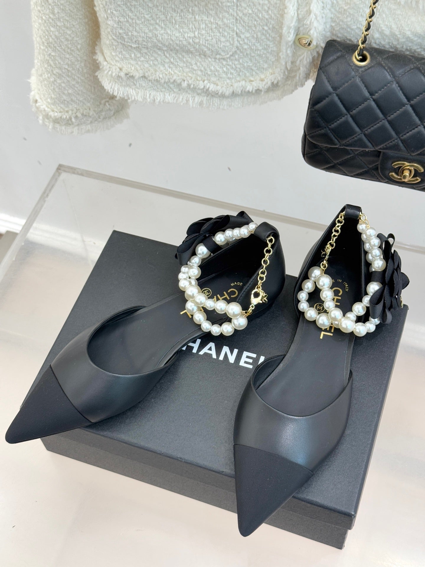 Chanel ladies black mules with pearl straps and gold chain accents, pointed toe