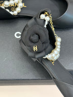 Chanel ladies black mules: close-up of faux pearl strap and gold chain charm