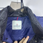 Moncler puffer jacket chest logo patch on blue interior panel, visible zipper and button placket