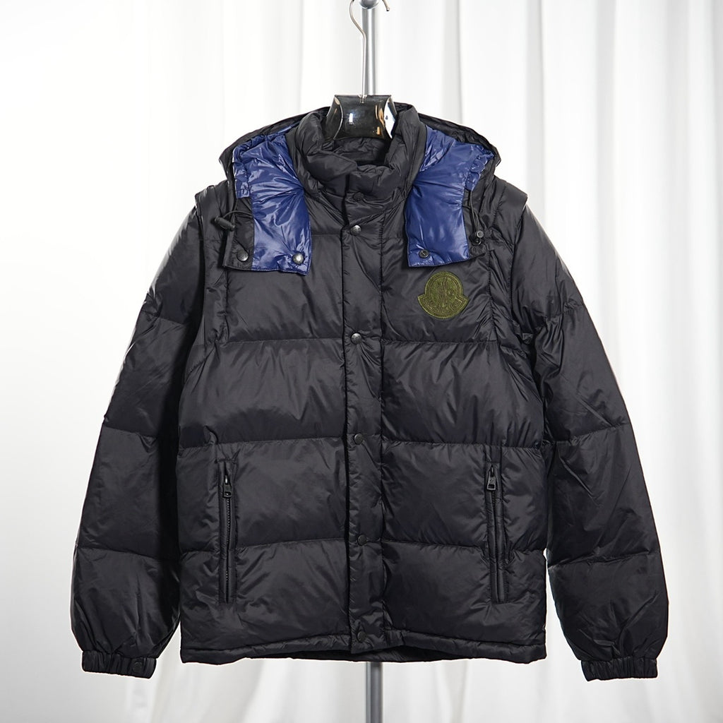 Moncler long puffer jacket front view, dark body with blue shoulder panels, hood, logo badge