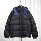Moncler long puffer jacket front view, dark body with blue shoulder panels, hood, logo badge