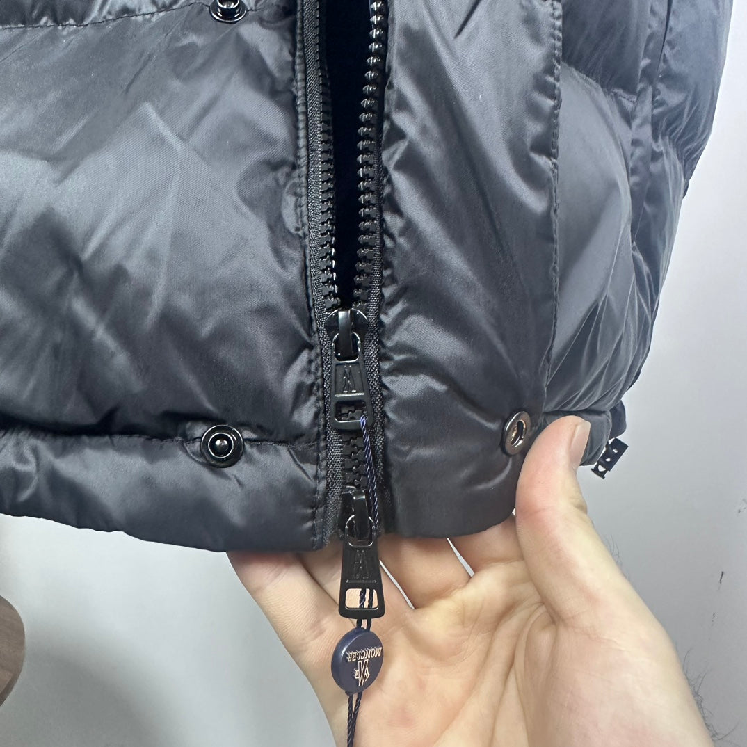 Moncler puffer jacket zipper and pull tab detail on dark quilted outer shell
