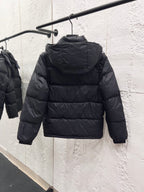 Moncler long puffer jacket back view on hanger, dark quilted puffer with hood