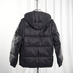 Moncler long puffer jacket back view, dark quilted puffer with hood, zip at center