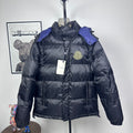 Moncler long puffer jacket with hood, dark shell, quilted panels, zip front, logo badge