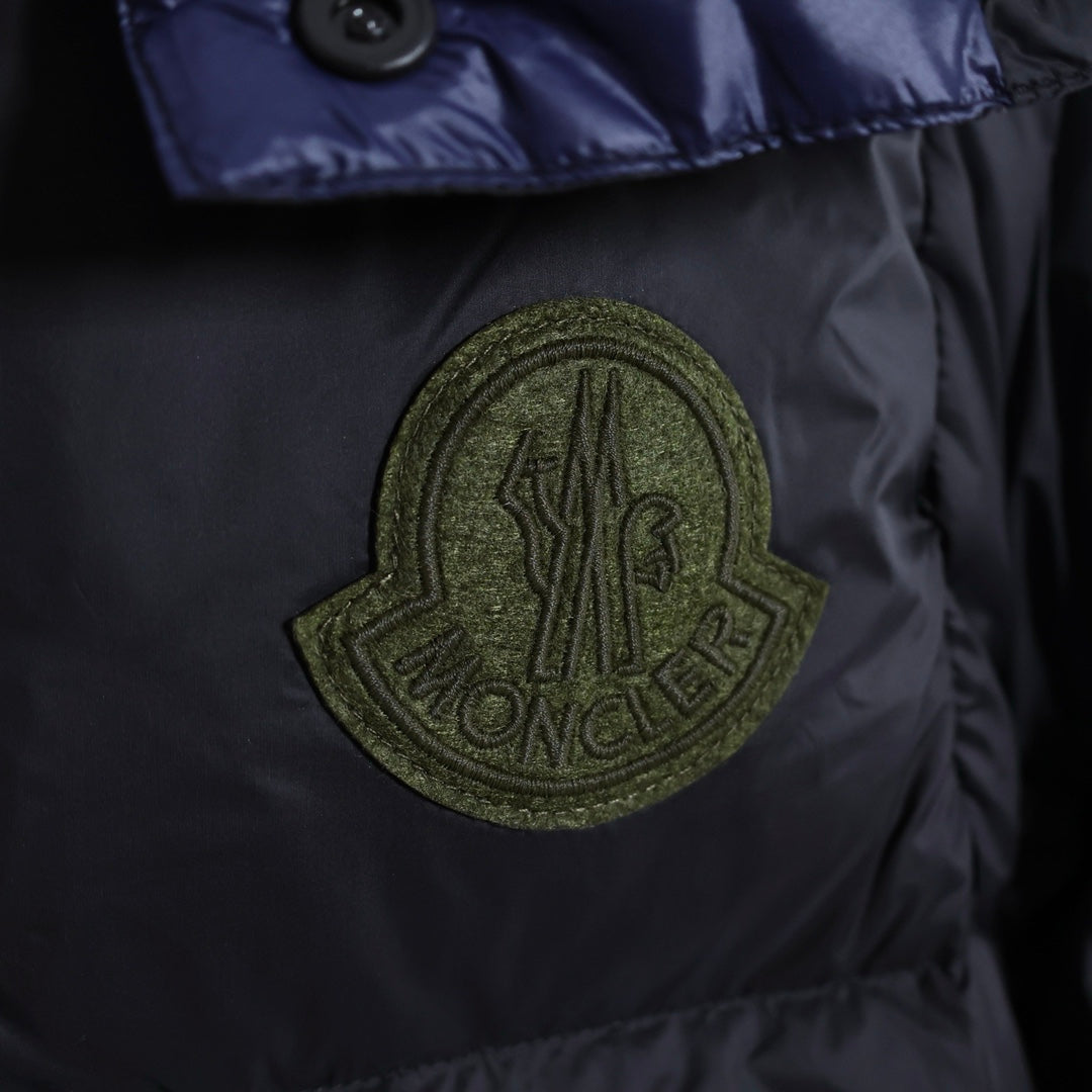 Moncler logo patch on dark puffer jacket chest panel