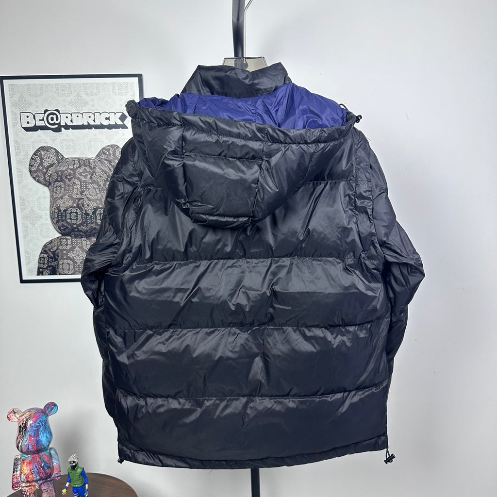 Moncler long puffer jacket back view, hooded, dark with blue shoulder panel, quilted zip