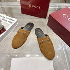 Gucci unisex GG-pattern mules with gold horsebit, dark lining, angled pair view