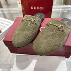 Gucci unisex loafers close-up with GG monogram, olive fabric and gold horsebit, black