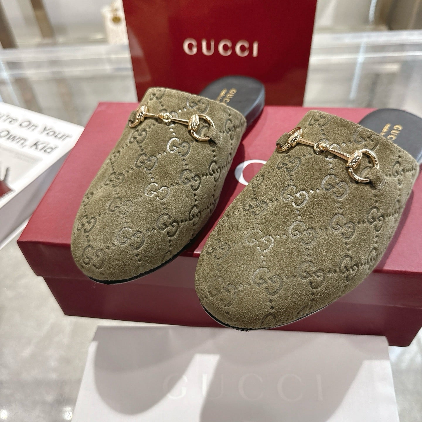 Gucci unisex loafers close-up with GG monogram, olive fabric and gold horsebit, black