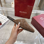 Gucci unisex mule with GG monogram upper and gold-tone horsebit, side profile, brown