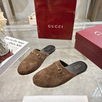 Gucci unisex mules pair with GG monogram fabric and gold-tone horsebit on brown