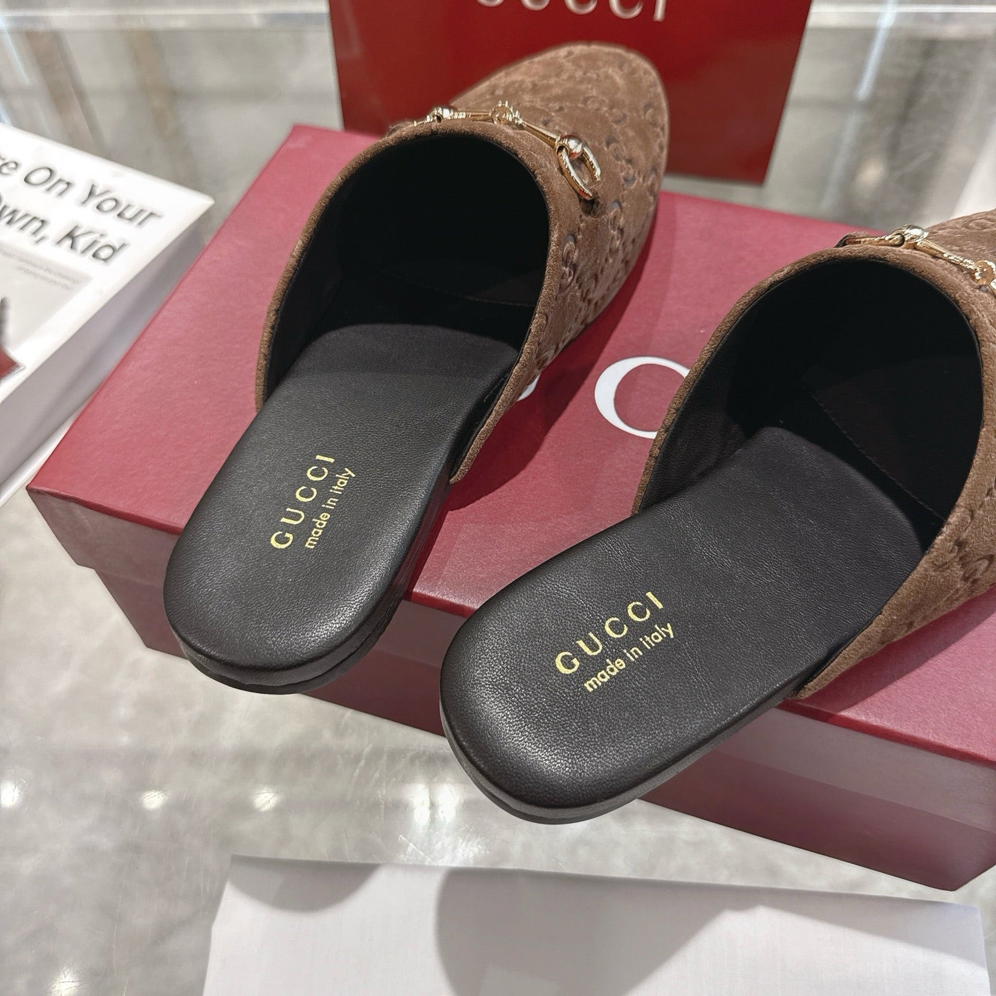 Gucci unisex mules with GG monogram top and black leather footbed, brown