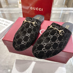 Gucci unisex mule slides, black GG pattern with gold horsebit rings, low profile