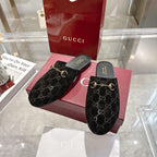 Gucci unisex GG-print mule slides, black with gold horsebit hardware and dark footbeds