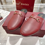 Gucci unisex mules in burgundy leather with gold horsebit, close front view