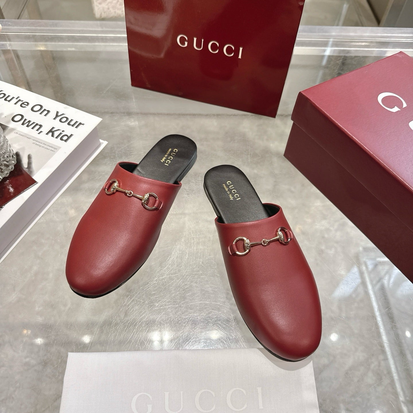 Gucci unisex loafers in burgundy leather with gold horsebit, black slip-on mules