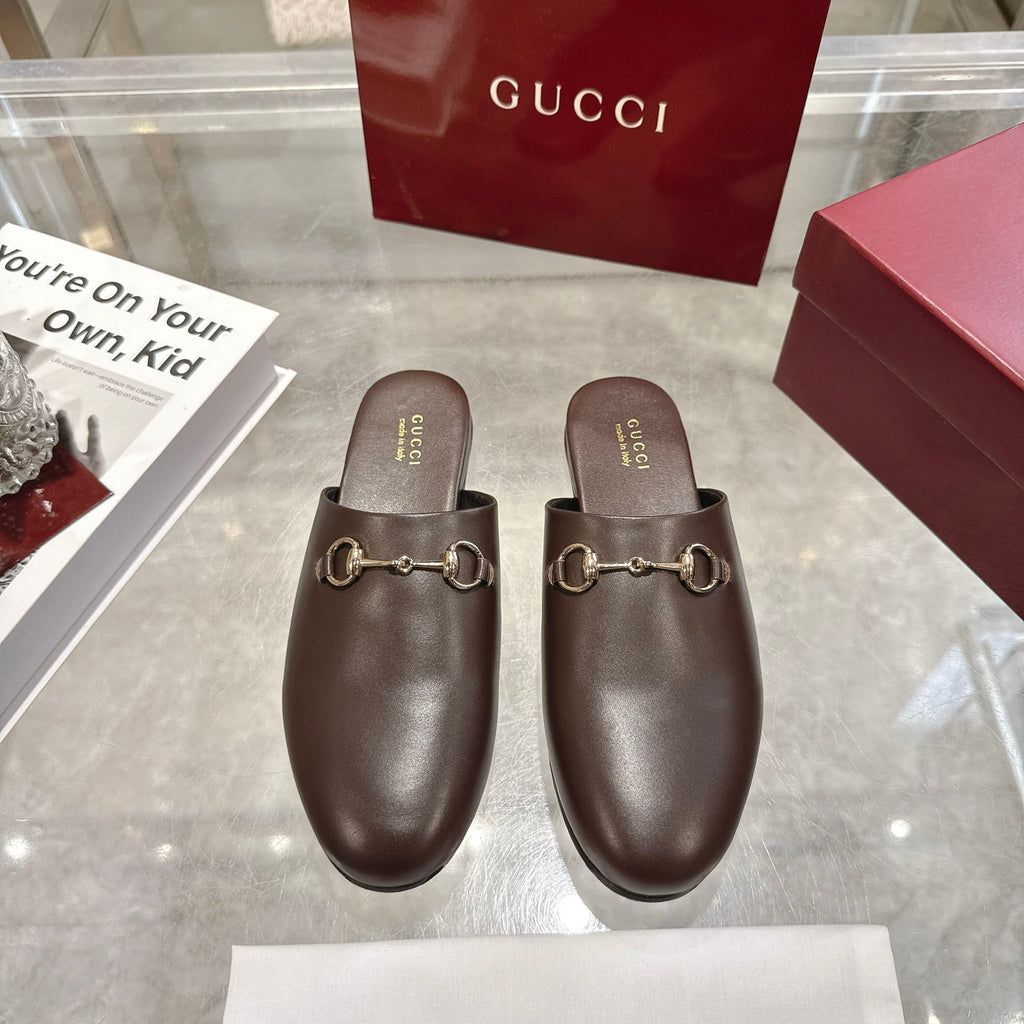 Gucci unisex leather loafers with gold-toned horsebit hardware, rounded toe, slip-on.