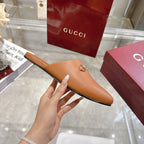 Gucci tan leather mule slide with gold-tone horsebit detail, side view