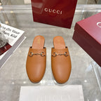 Gucci tan leather slide sandals with gold-tone horsebit detail