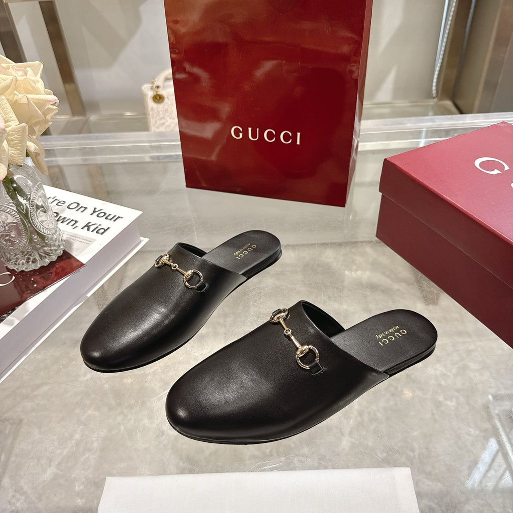 Gucci black leather mule shoes with gold-tone horsebit detail, slip-on design