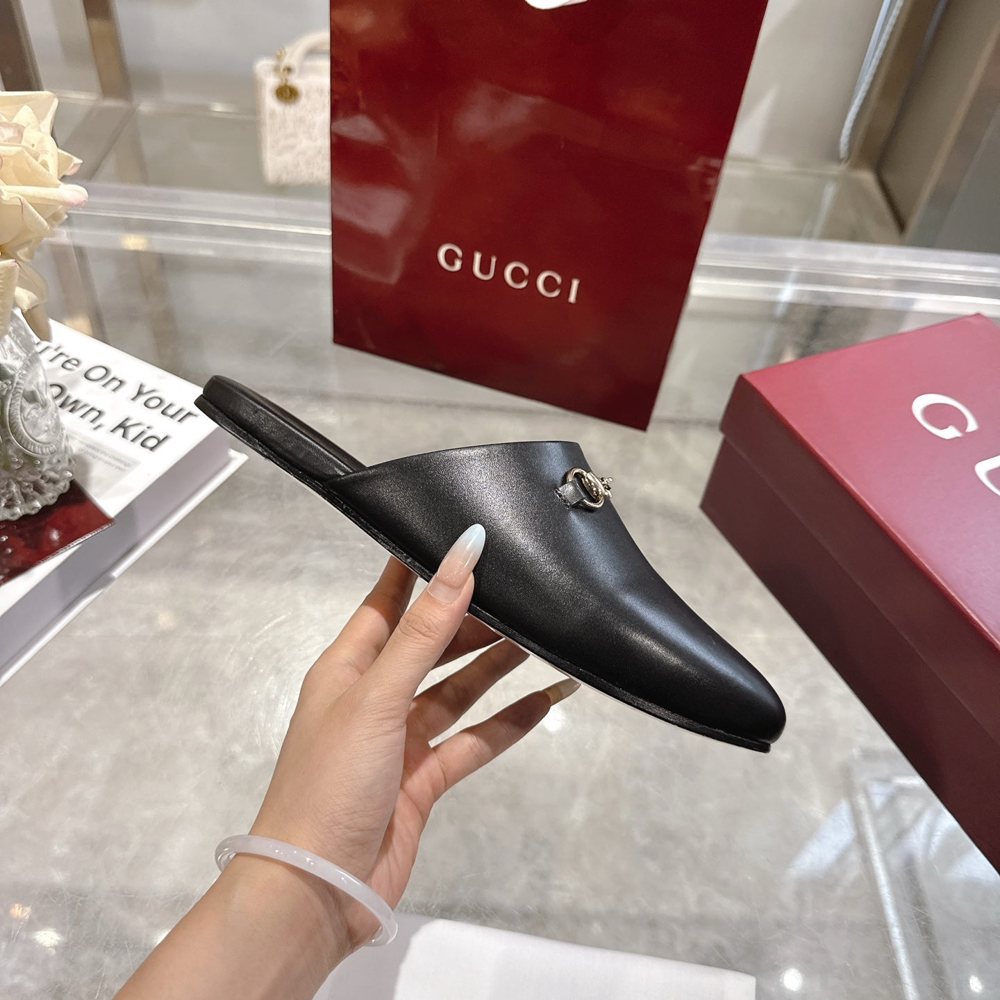 Gucci black leather horsebit mule, side profile slip-on with gold-tone hardware