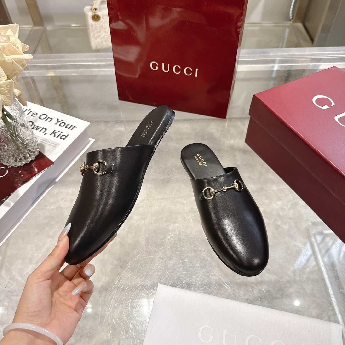 Gucci black leather horsebit mules, slip-on style with gold-tone ring detail