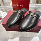 Gucci black leather horsebit mules with gold-tone rings on vamp, slip-on