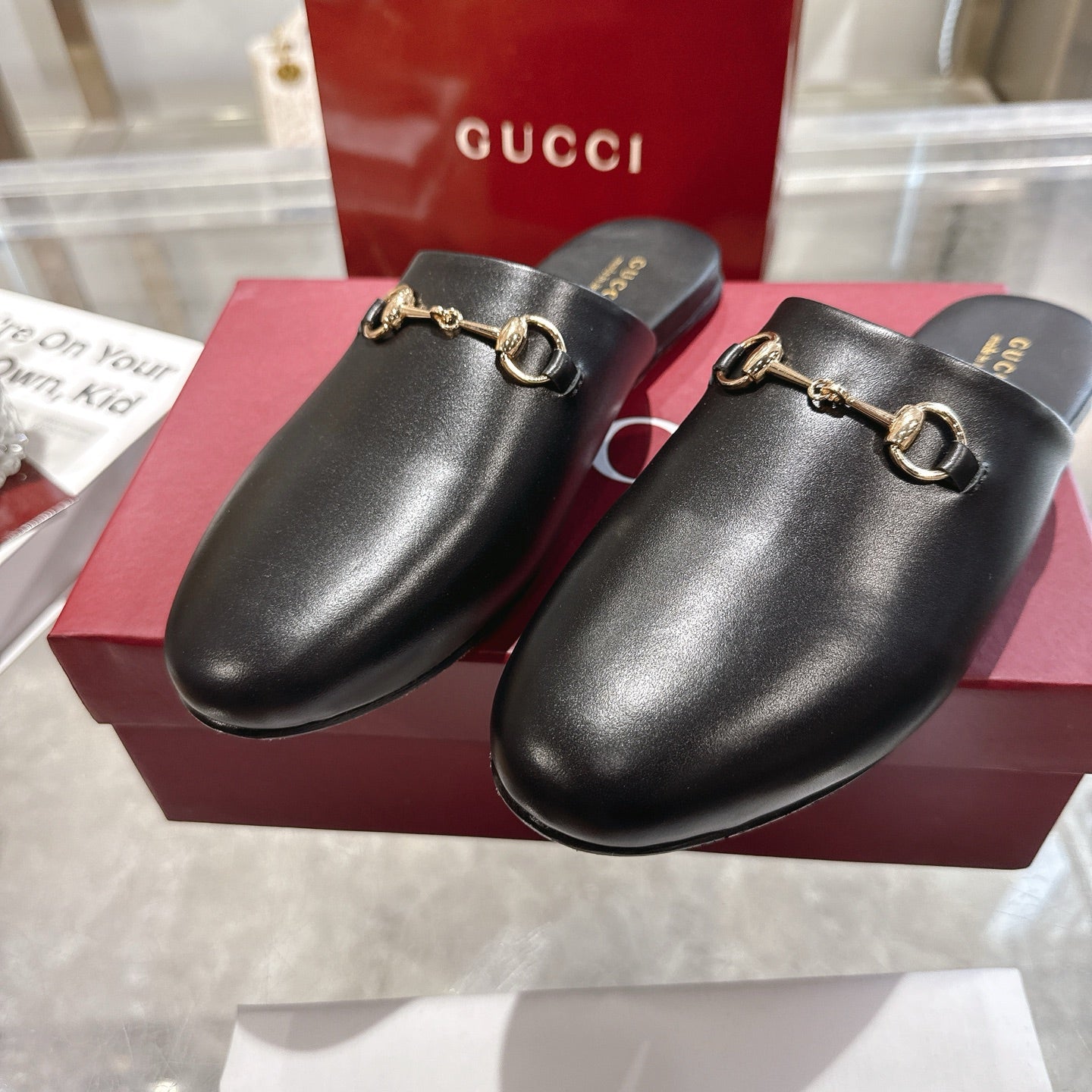 Gucci black leather horsebit mules with gold-tone rings on vamp, slip-on