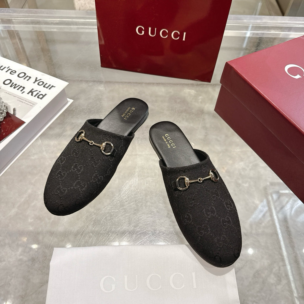 Gucci unisex slip-on mules in dark monogram fabric with gold horsebit detail