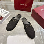 Gucci unisex slip-on mules in dark monogram fabric with gold horsebit detail
