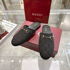Gucci unisex slip-on mules in dark monogram fabric with gold horsebit on black sandals