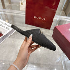 Gucci unisex mule sandal in dark monogram fabric with gold horsebit detail, side view