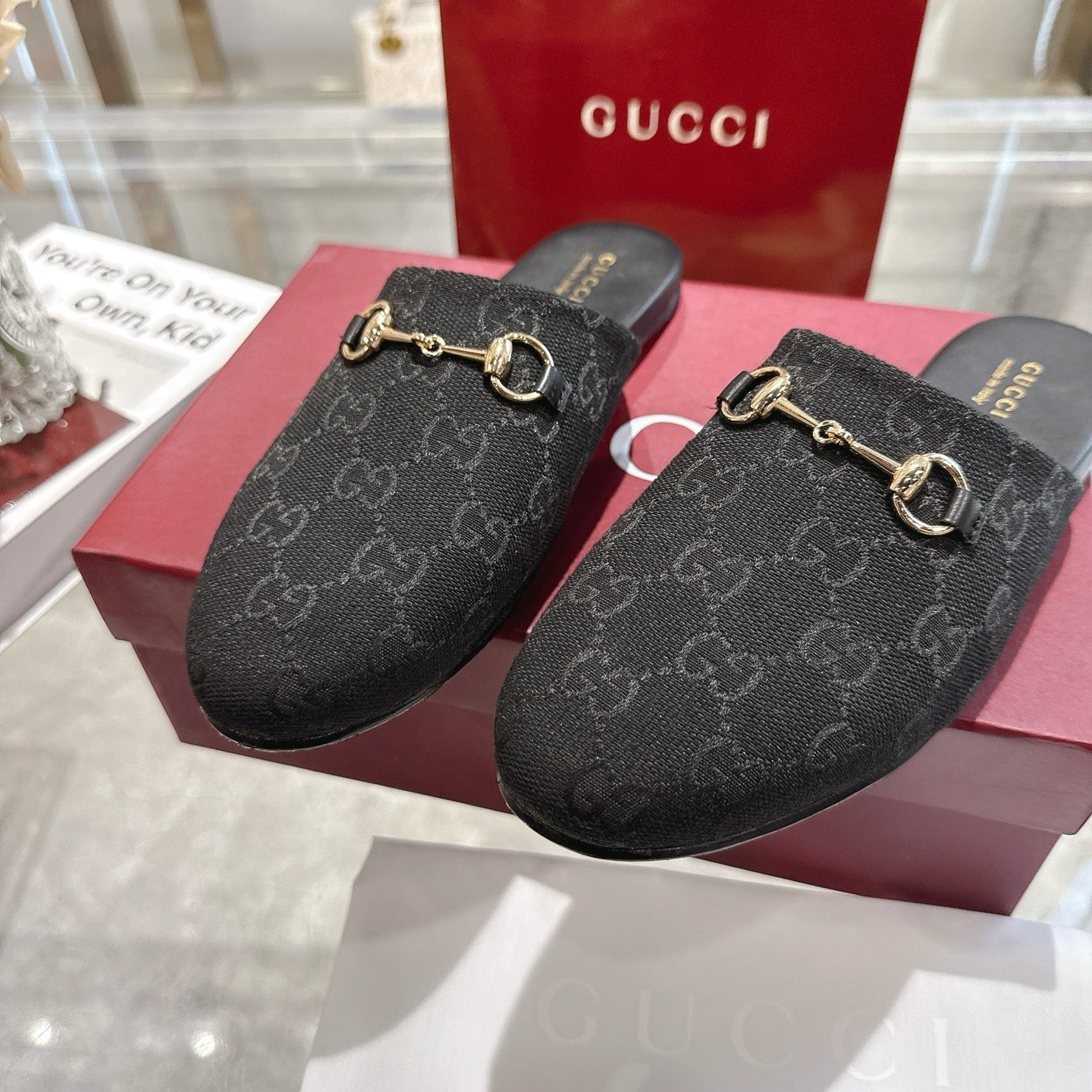 Gucci unisex mules, dark monogram fabric upper with gold horsebit buckle detail