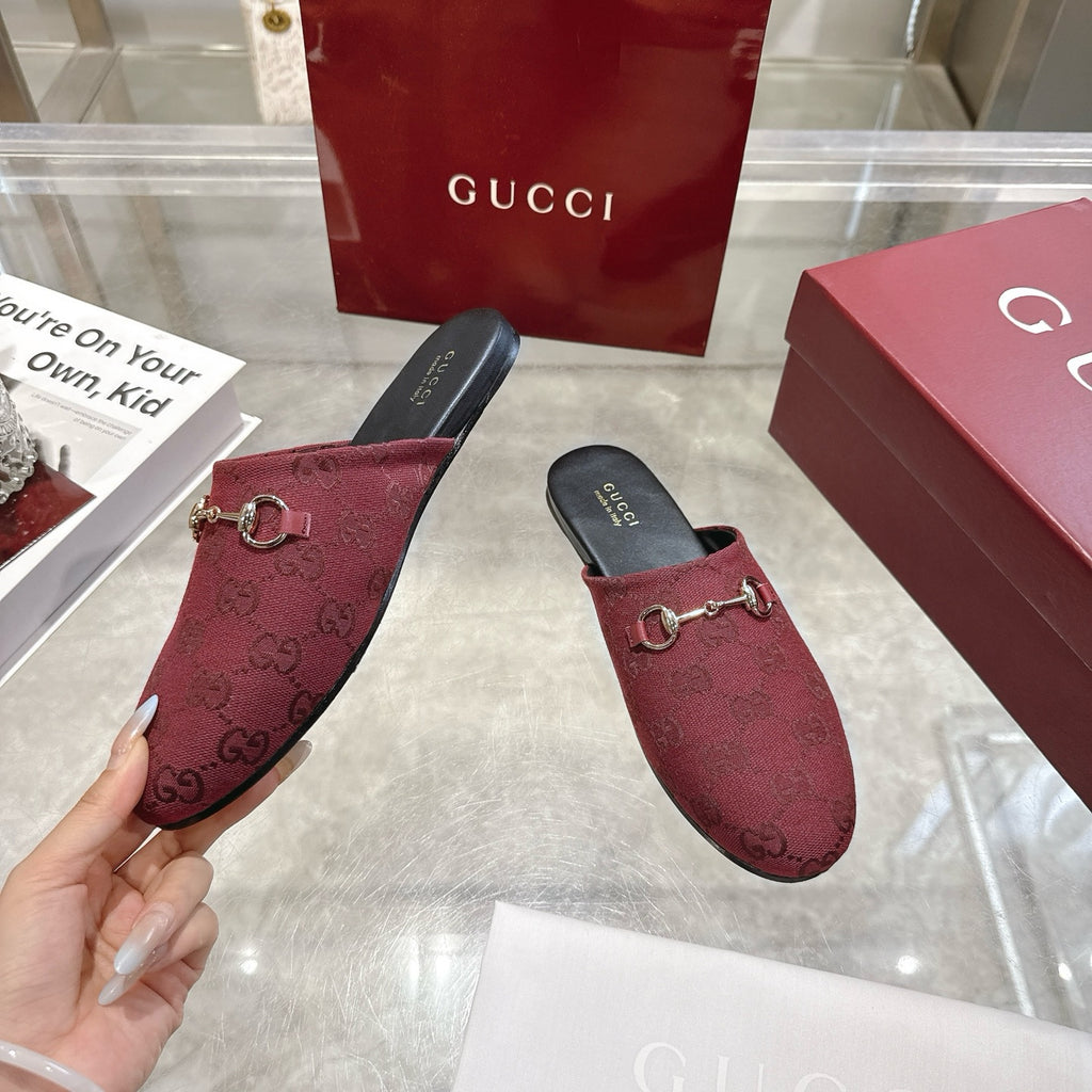 Burgundy Gucci unisex horsebit slide with GG texture and gold-tone bit, side view